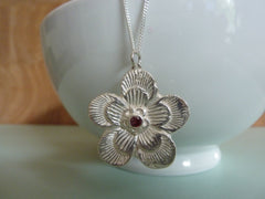 Large flower with pink cubic zirconia centre
