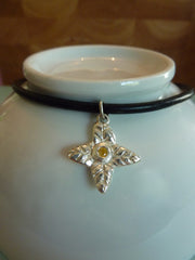 Four leaf flower with yellow cubic zirconia